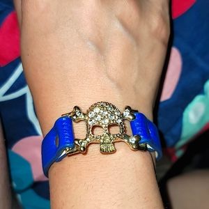Skull & Bones bracelet bejeweled blue leather strap snap closure skulls